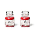 Rose scented candle in clear glass jar with metal lid and red wax