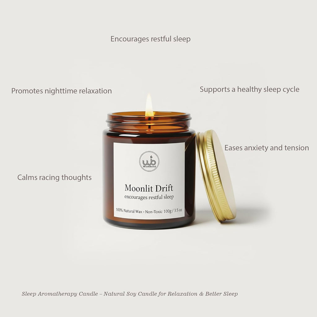 Moonlit Drift soy candle in amber glass jar with gold lid, lit wick
