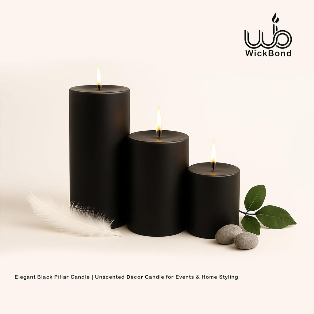 Black dripless pillar candles, three flames with wick tops visible