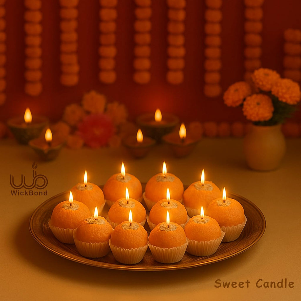 Lit Motichoor ladoo candles on round tray, orange spheres with star wick tops