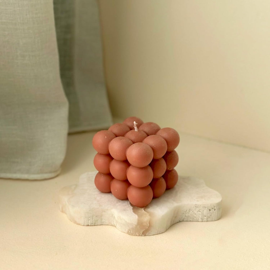 Bubble soy wax cube candle with orange-brown clustered wax balls and a visible wick