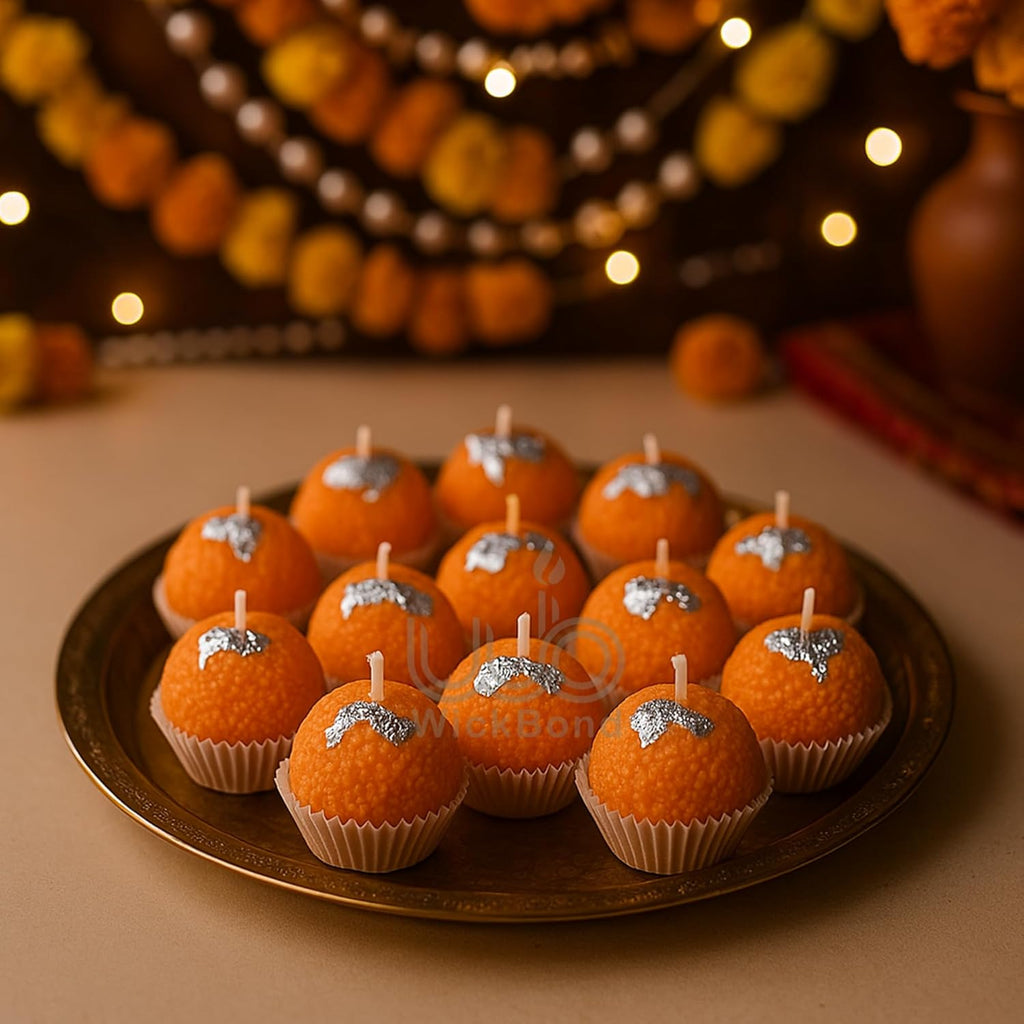Motichoor ladoo candles in paper cups on tray, orange spheres with star details