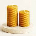 Two honeycomb-pattern beeswax pillar candles, set of 2, golden honey color